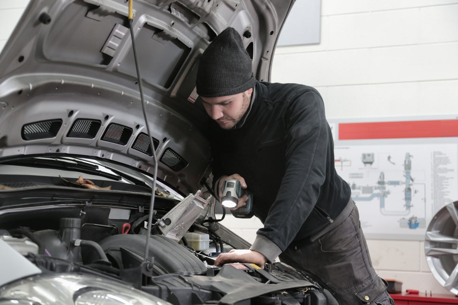 Mechanic working under the bonnet of a car